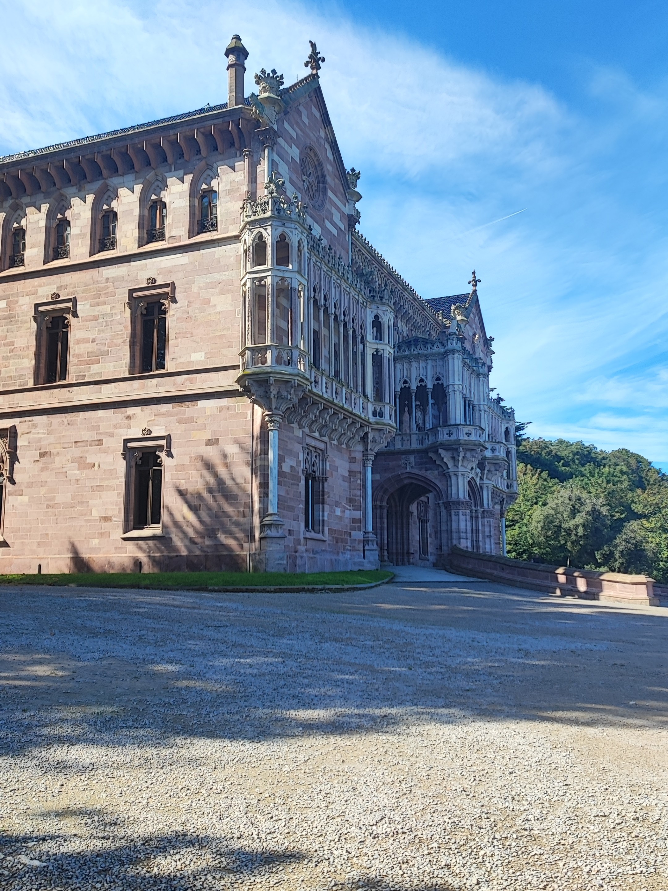 Historic stone building with ornate details and arched entrance.