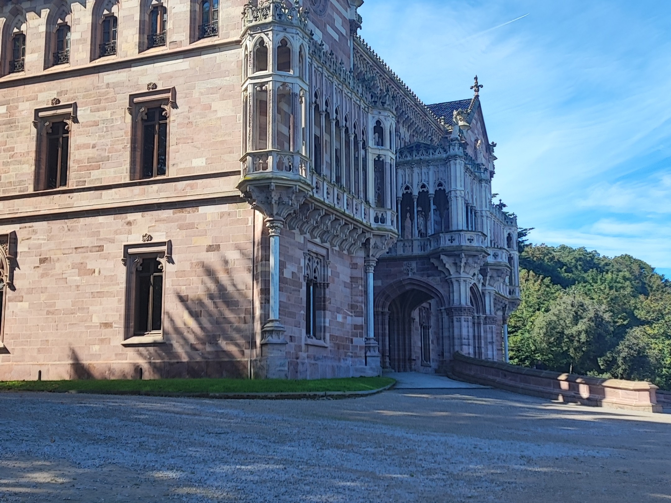 Historic stone building with ornate details and arched entrance.