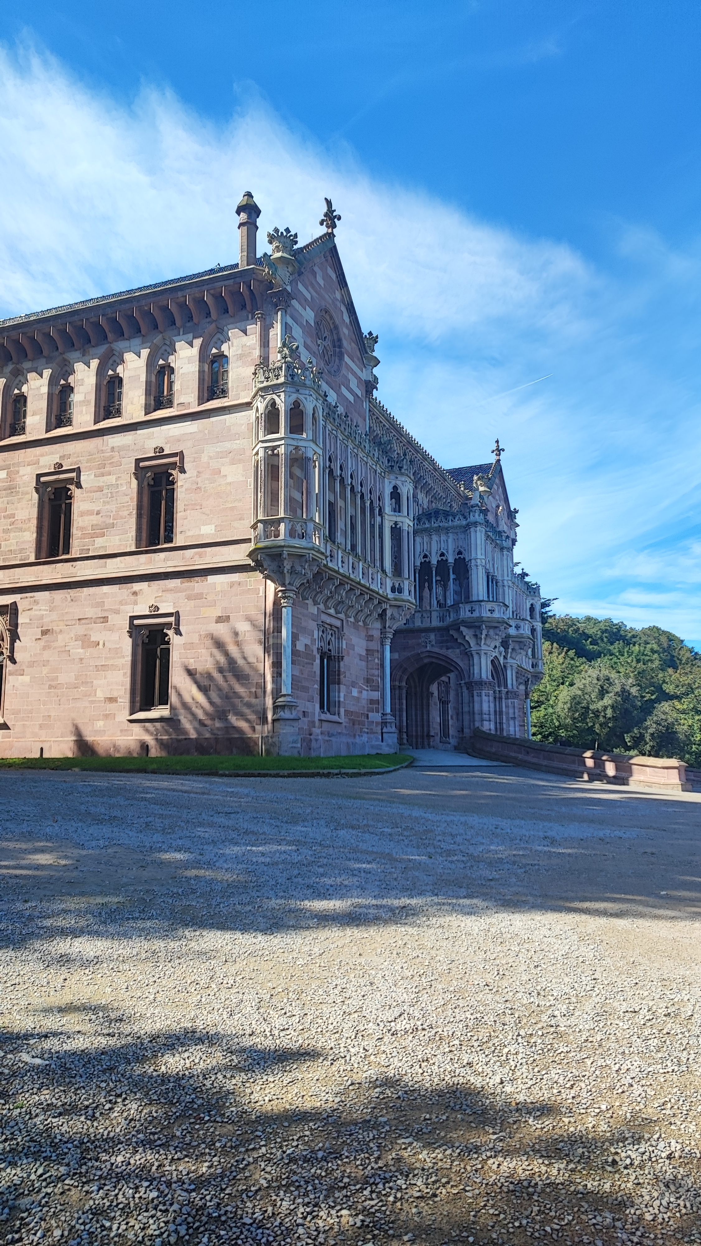 Historic stone building with ornate details and arched entrance.