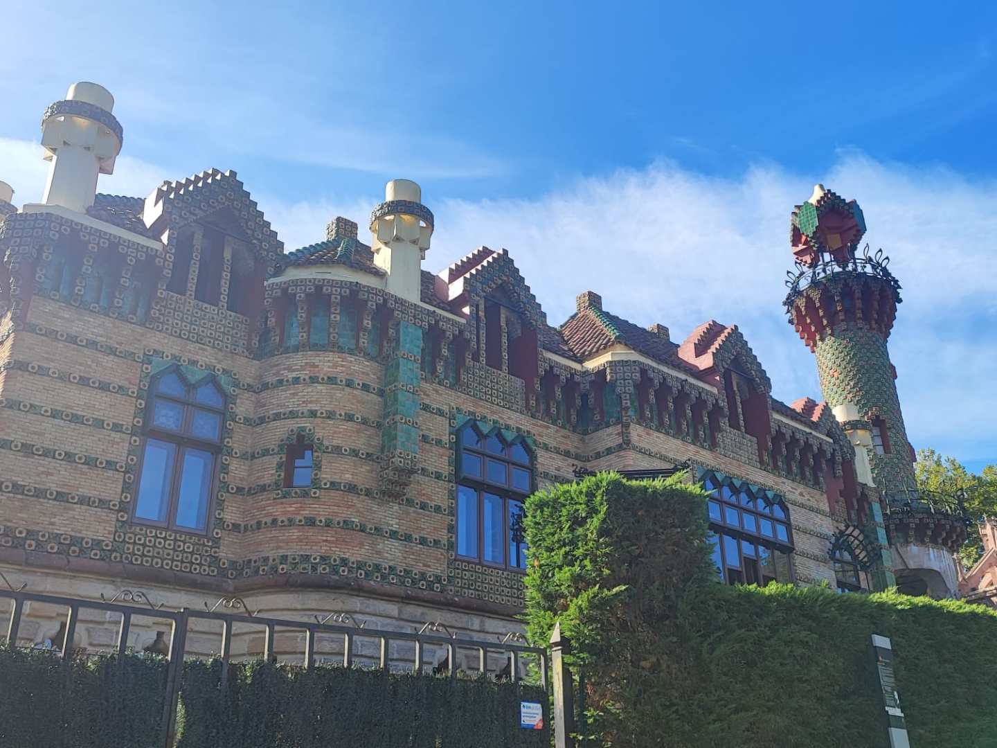 Colorful, ornate building with towers and blue sky.